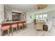 Open-concept living space with a wet bar, casual seating, and view of the backyard at 506 S Casey Key Rd, Nokomis, FL 34275