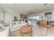 Bright and airy living room with casual seating and access to an outdoor area at 506 S Casey Key Rd, Nokomis, FL 34275