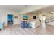 Open-concept living room with modern decor, with staircase leading to the upper floor at 506 S Casey Key Rd, Nokomis, FL 34275
