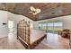 Spacious main bedroom features wood ceiling, ceiling fan, waterfront views, and balcony access at 506 S Casey Key Rd, Nokomis, FL 34275