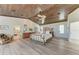 Bright main bedroom with wood ceiling, accent furnishings, and ensuite bath access at 506 S Casey Key Rd, Nokomis, FL 34275