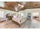 Light and airy main bedroom featuring light wood floors, wood ceiling, and stylish decor at 506 S Casey Key Rd, Nokomis, FL 34275