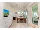 Home office with built-in shelving, desk, and access to a waterfront balcony at 506 S Casey Key Rd, Nokomis, FL 34275