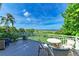 Outdoor deck offers ocean views, comfortable seating and a table for relaxing and enjoying the beach scene at 506 S Casey Key Rd, Nokomis, FL 34275