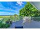 Relaxing outdoor deck with white railing, ocean views, and comfortable seating to enjoy the beach scene at 506 S Casey Key Rd, Nokomis, FL 34275