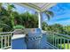 Built-in stainless steel outdoor grill with granite countertop on a covered patio with tropical landscaping at 506 S Casey Key Rd, Nokomis, FL 34275