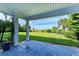 Tranquil patio overlooking a lush green lawn with a path leading to the beach at 506 S Casey Key Rd, Nokomis, FL 34275