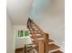 Modern staircase with wood steps and unique cable railing, illuminated by ambient lighting at 506 S Casey Key Rd, Nokomis, FL 34275