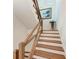 Staircase featuring wooden railings and a painting at 506 S Casey Key Rd, Nokomis, FL 34275