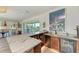Well-equipped wet bar with marble counters, a beverage fridge, and sink at 506 S Casey Key Rd, Nokomis, FL 34275