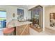 Elegant wet bar with granite countertop, wine storage, and stylish cabinetry at 506 S Casey Key Rd, Nokomis, FL 34275