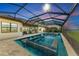 Stunning pool and spa at sunset with covered lanai and comfortable seating; golf course view at 5622 Mulligan Way, Bradenton, FL 34211