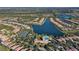 Aerial view of community with lake and homes at 5759 Benevento Dr, Sarasota, FL 34238