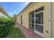 Landscaped backyard with a patio and screened enclosure at 5759 Benevento Dr, Sarasota, FL 34238