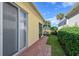 Brick-paved walkway leads to a screened patio at 5759 Benevento Dr, Sarasota, FL 34238