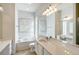 Bathroom with soaking tub, double vanity, and large mirror at 5759 Benevento Dr, Sarasota, FL 34238