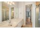 Bathroom with vanity, mirror and view into hallway at 5759 Benevento Dr, Sarasota, FL 34238