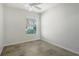 Simple bedroom with window and ceiling fan at 5759 Benevento Dr, Sarasota, FL 34238