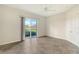 Bedroom with tile floors and sliding glass doors with water view at 5759 Benevento Dr, Sarasota, FL 34238