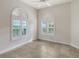 Spacious bedroom with arched windows and tile flooring at 5759 Benevento Dr, Sarasota, FL 34238