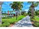 Relaxing paved path meanders through lush landscaping, leading to bocce ball courts at 5759 Benevento Dr, Sarasota, FL 34238
