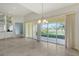Bright dining room with sliders leading to a patio and water view at 5759 Benevento Dr, Sarasota, FL 34238