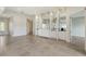 Spacious dining room with tile flooring and built-in shelving at 5759 Benevento Dr, Sarasota, FL 34238