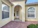 Front entry with arched detail and brick flooring at 5759 Benevento Dr, Sarasota, FL 34238