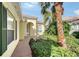 Covered entryway with arched doorway and brick walkway at 5759 Benevento Dr, Sarasota, FL 34238