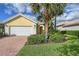 Single-story house with a two-car garage and well-manicured lawn at 5759 Benevento Dr, Sarasota, FL 34238