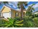 Attractive yellow house with lush landscaping at 5759 Benevento Dr, Sarasota, FL 34238