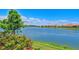 Scenic lake view with lush landscaping and beautiful homes at 5759 Benevento Dr, Sarasota, FL 34238