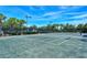 Well-lit tennis court, perfect for a game under the sun at 5759 Benevento Dr, Sarasota, FL 34238