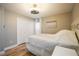 Light and airy bedroom with hardwood floors and white bedding at 612 Foxwood Blvd # 612, Englewood, FL 34223