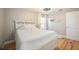 Bright bedroom with hardwood floors, white bedding, and built-in shelves at 612 Foxwood Blvd # 612, Englewood, FL 34223