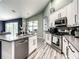 Kitchen with stainless steel appliances, white cabinets, and island with sink at 6723 Tailfeather Way, Bradenton, FL 34203