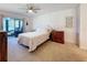 Main bedroom with a queen-size bed and access to a private patio at 707 Sorrento Inlt # 707, Nokomis, FL 34275