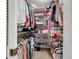 Large walk-in closet with custom shelving and hanging rods at 707 Sorrento Inlt # 707, Nokomis, FL 34275