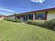 Back exterior, showcasing a large grassy area at 707 Sorrento Inlt # 707, Nokomis, FL 34275