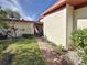 Side view of house exterior with walkway and landscaping at 707 Sorrento Inlt # 707, Nokomis, FL 34275