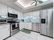 Modern kitchen with stainless steel appliances and white cabinets at 707 Sorrento Inlt # 707, Nokomis, FL 34275