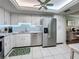 Modern kitchen with stainless steel appliances and white cabinetry at 707 Sorrento Inlt # 707, Nokomis, FL 34275