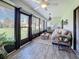 Relaxing sunroom with comfy seating, wood-look floors, and access to the backyard at 707 Sorrento Inlt # 707, Nokomis, FL 34275