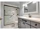 Updated bathroom with gray vanity, marble shower, and modern fixtures at 741 Fairway Ridge Ct, Sun City Center, FL 33573