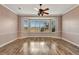 Bright bedroom featuring wood floors and a large window with plantation shutters at 741 Fairway Ridge Ct, Sun City Center, FL 33573