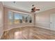 Spacious bedroom with wood flooring, large window, and ceiling fan at 741 Fairway Ridge Ct, Sun City Center, FL 33573
