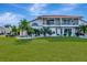 Two-story home with a red tile roof and lush lawn at 741 Fairway Ridge Ct, Sun City Center, FL 33573