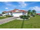 Single-story home with tile roof, landscaped yard, and two-car garage at 741 Fairway Ridge Ct, Sun City Center, FL 33573