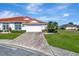 House exterior showcasing a paved driveway and lush landscaping at 741 Fairway Ridge Ct, Sun City Center, FL 33573