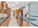 Open kitchen with granite countertops and wood cabinetry at 741 Fairway Ridge Ct, Sun City Center, FL 33573